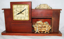 A mid-century lighted fireplace mantel clock